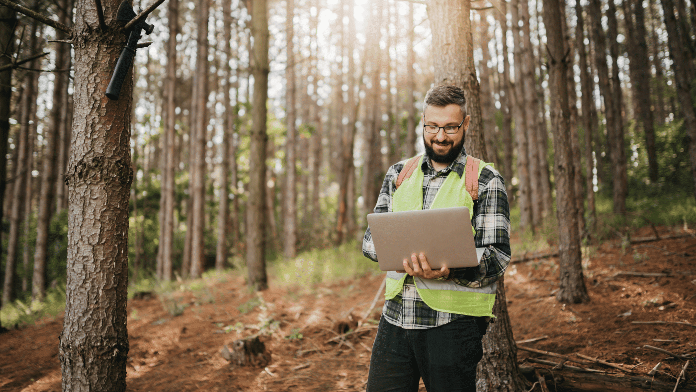 environmental testing in woods man with laptop