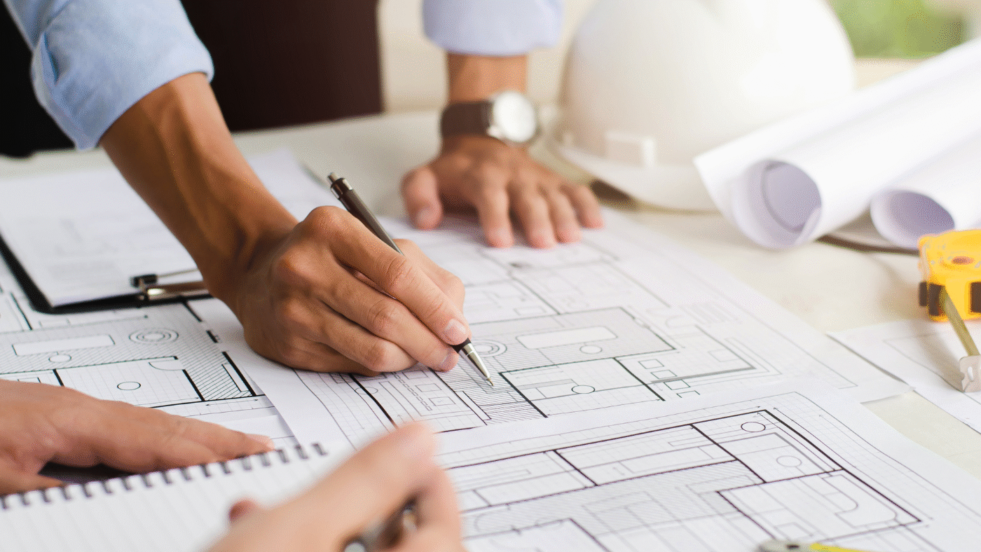 building-consultants-reviewing-documents-and-blueprints-vertex