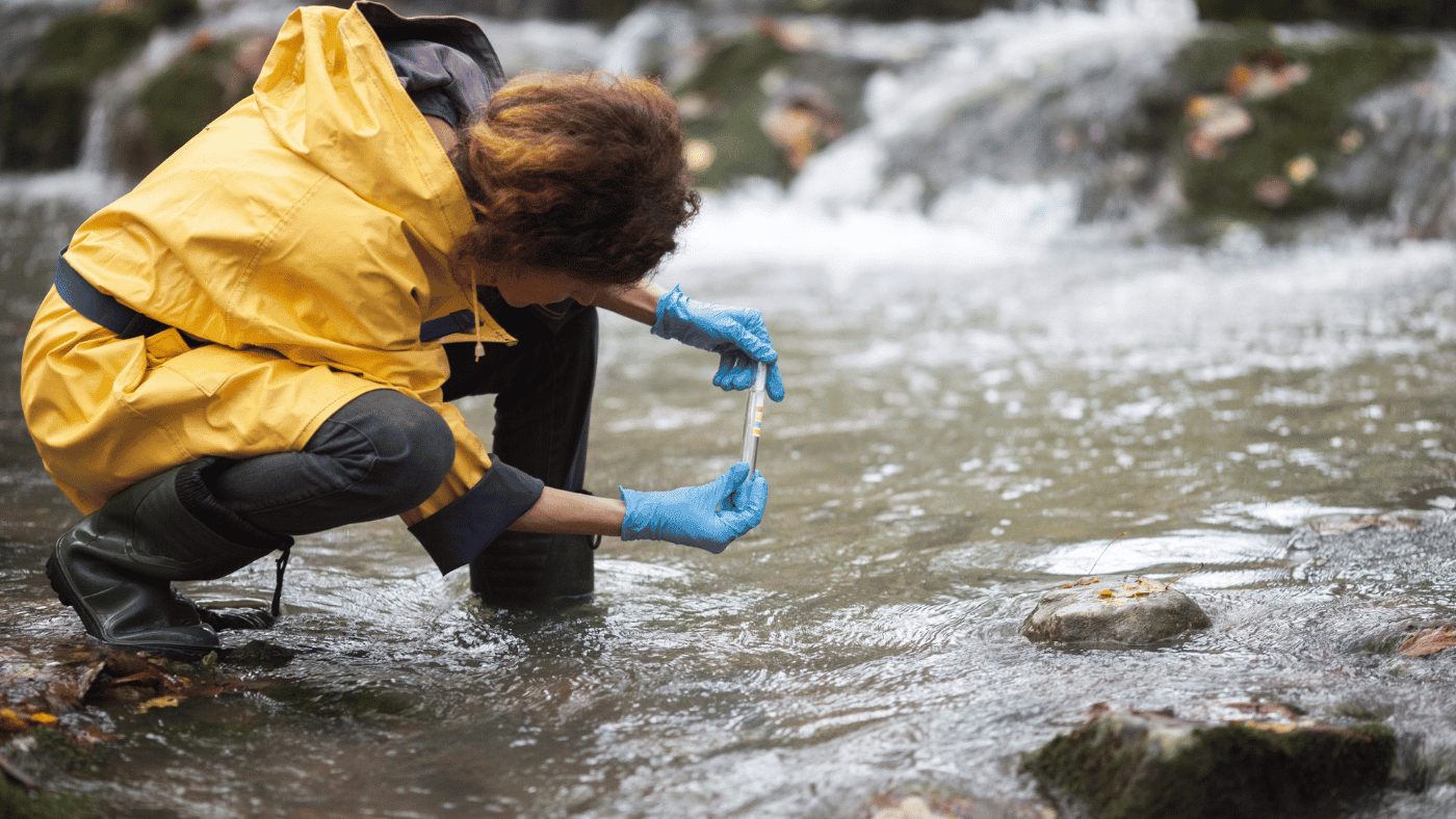 woman test water in river