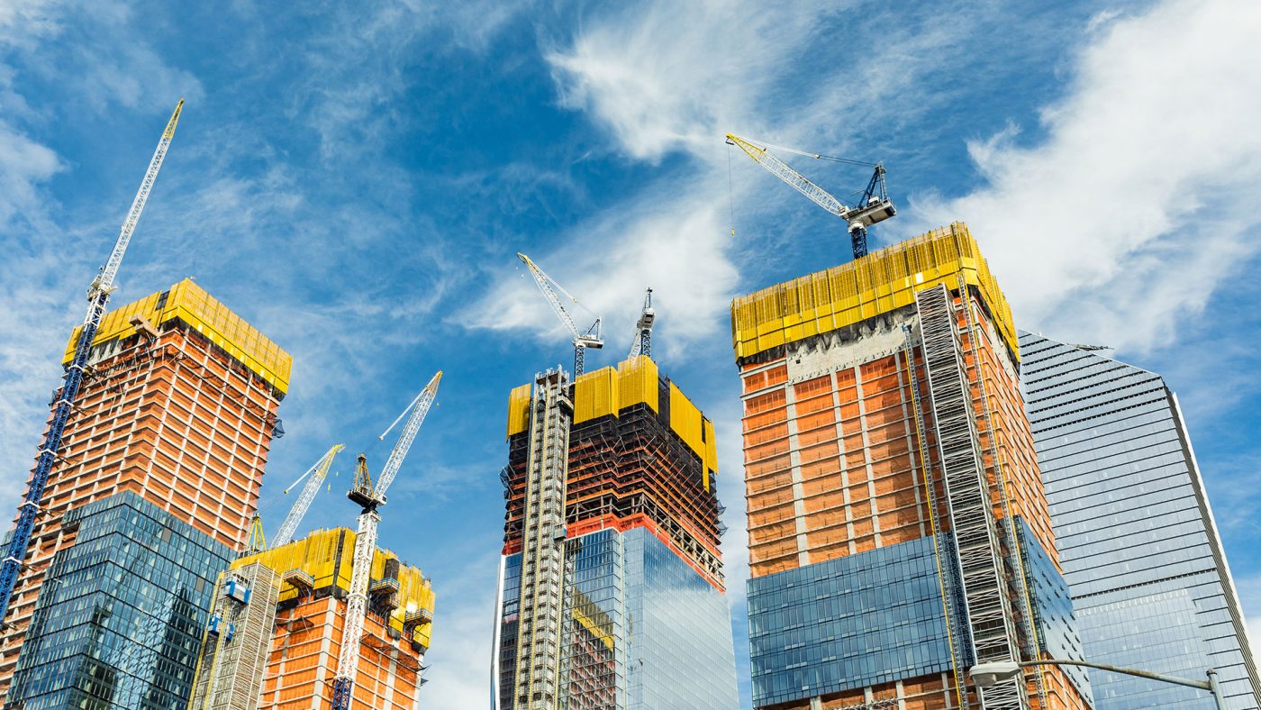 sky scrapper buildings in work with cranes