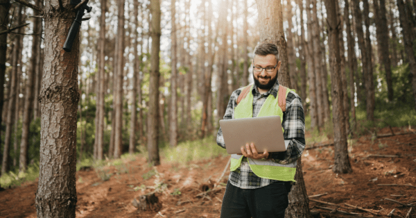 environmental testing in woods man with laptop